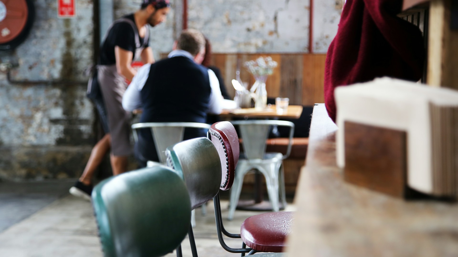 Barista making coffee in a busy café – hospitality job market