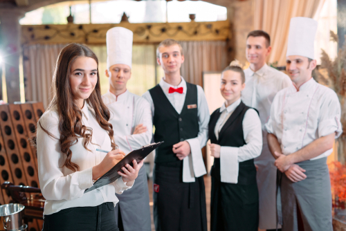 Kitchen team preparing fresh ingredients for a lunch service – catering hiring