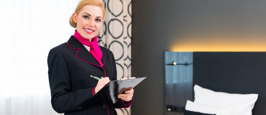 Kitchen porter washing large pots in a busy hotel kitchen – catering workforce