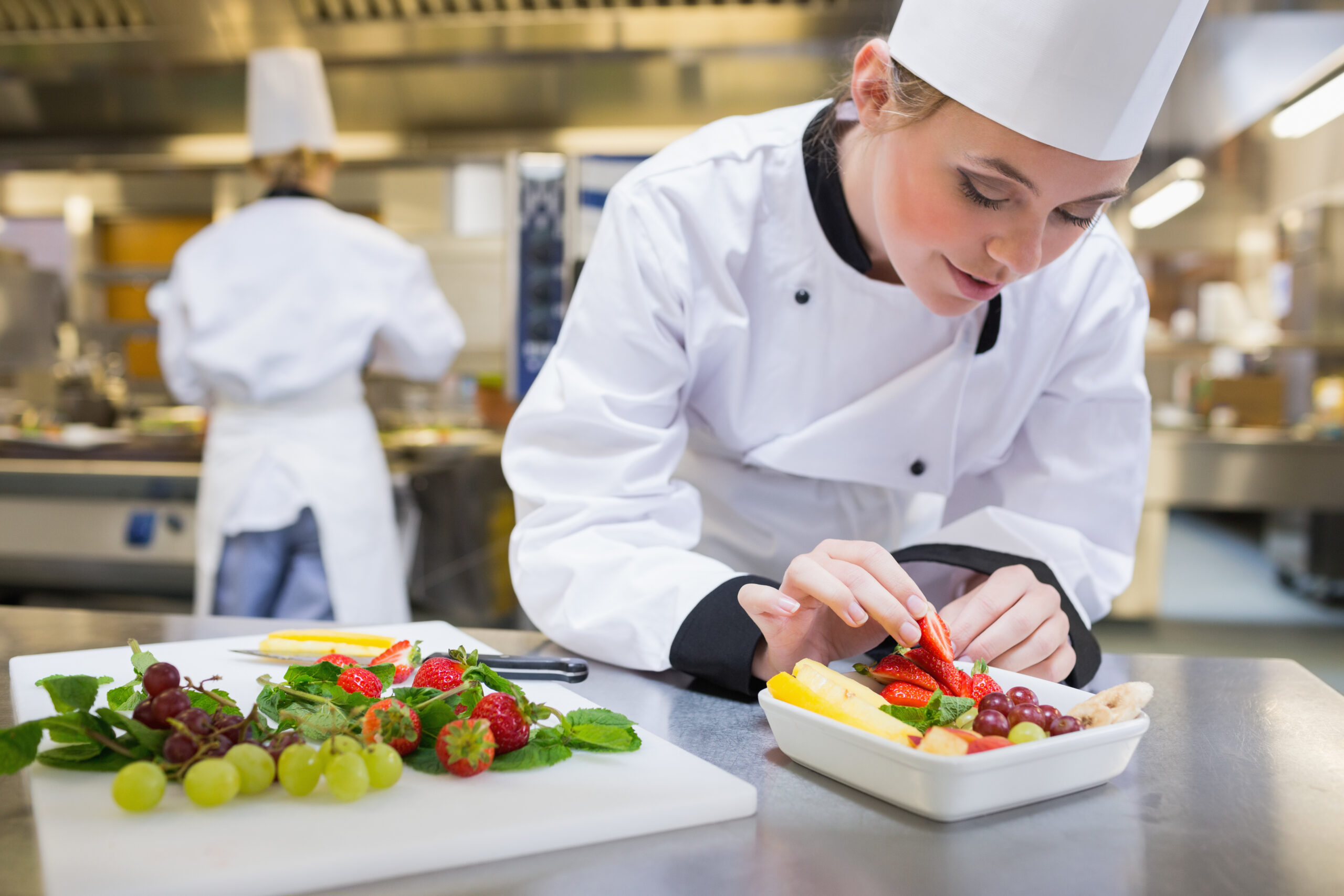 Chef,Putting,A,Strawberry,In,The,Fruit,Salad,In,The